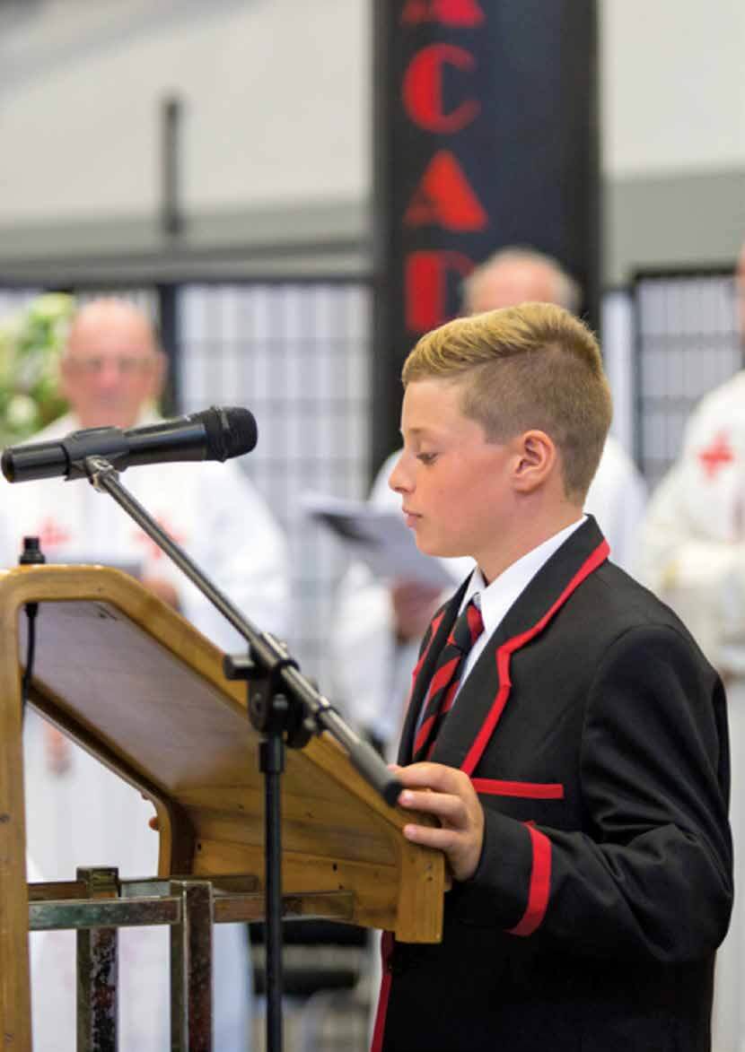 St Bede's College student at a lectern with microphone