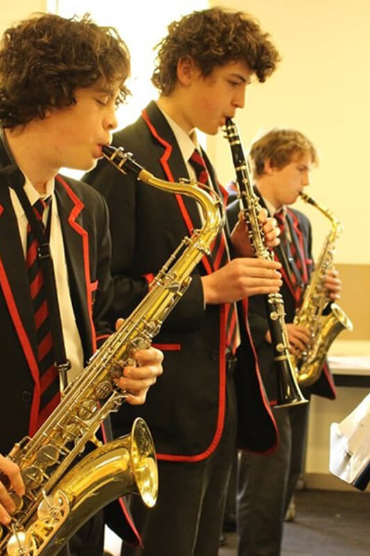 St Bede's College students playing wind instruments
